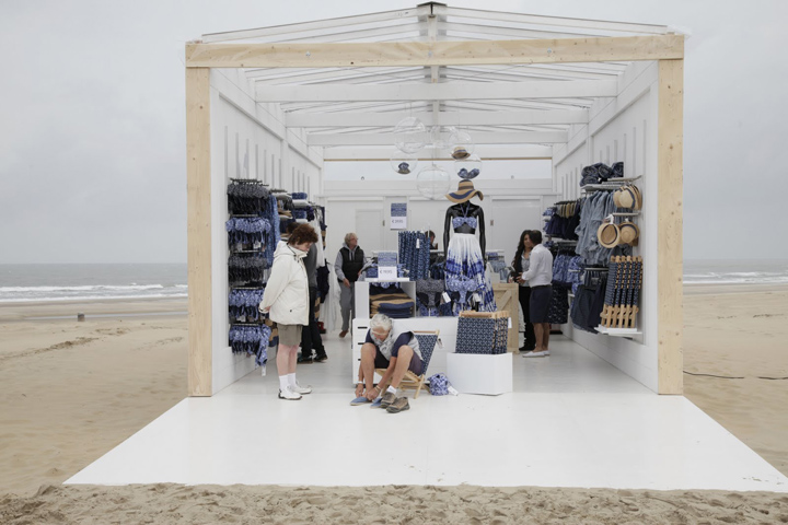 H&M's ephemeral space designed as a modern beach bar with wooden panels, clean aesthetics and a relaxed atmosphere.
